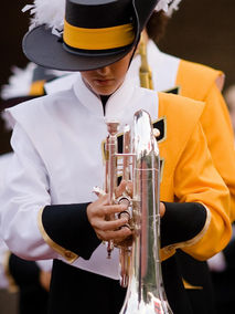 marching band student holding french horn