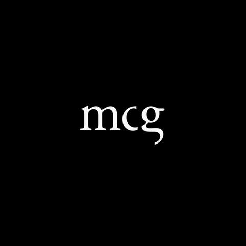 Serif lowercase "mcg" letters over black background