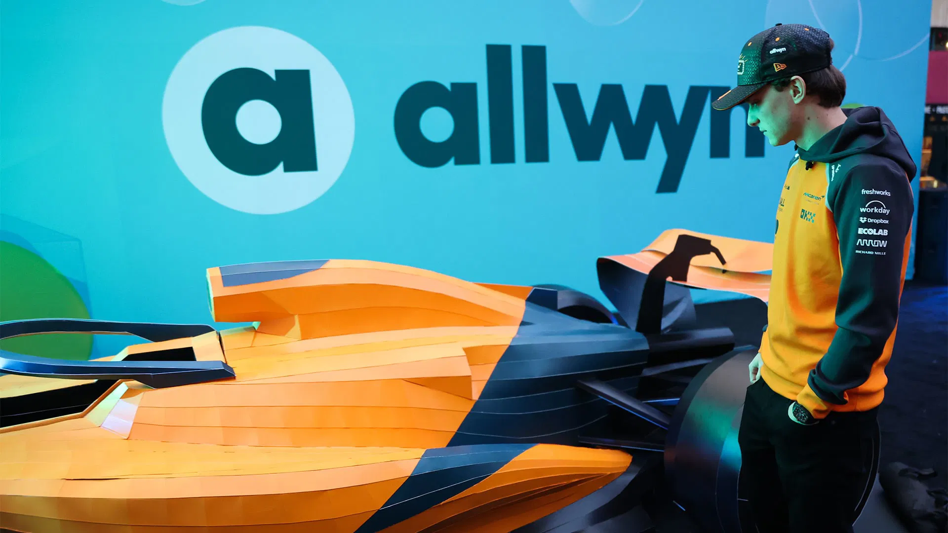 Allwyn McLaren Scratch Car Instagram social media post showing Oscar Piastri with papaya F1 car panels and blue branding during Las Vegas Grand Prix 2025 giveaway - JC Rubio emcee event