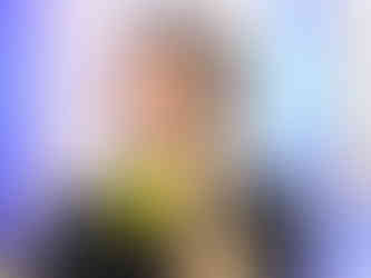 on-camera host JC Rubio hosting tv show recap podcasts with yellow mic and headphones