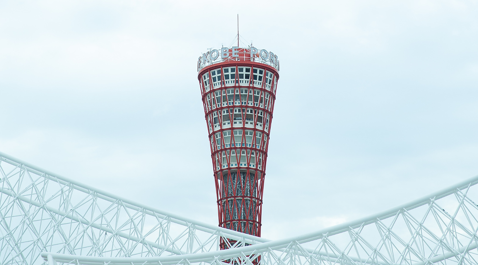 Red lattice tower labeled "Kobe Port" stands tall against a cloudy sky. White lattice structures are in the foreground.