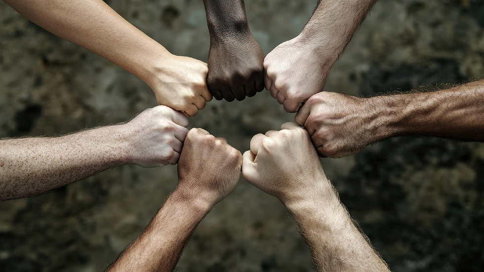 A bunch of human hands forming a fist and touching in a circle