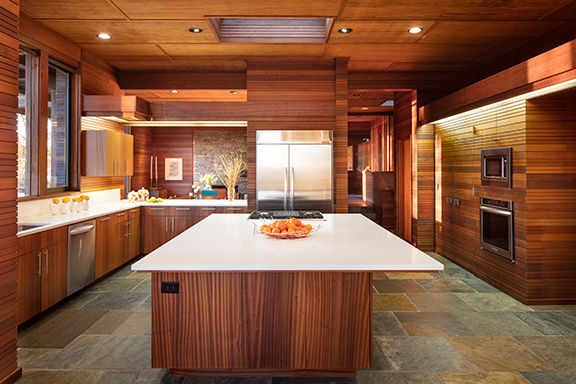 Kitchen of the Chedrick house restored by Trace Wilson with clean lines, wood cabinets and slate stone floor