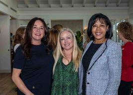 Colleen Lighter, Karen Benito, and Ernesta Johnson standing together during meet and greet at the Las Patronas luncheon event.