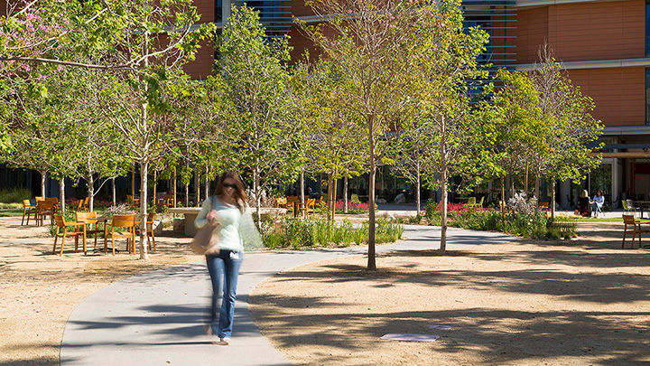 Woman walking through the grounds of Disney’s Grand Central Creative Campus