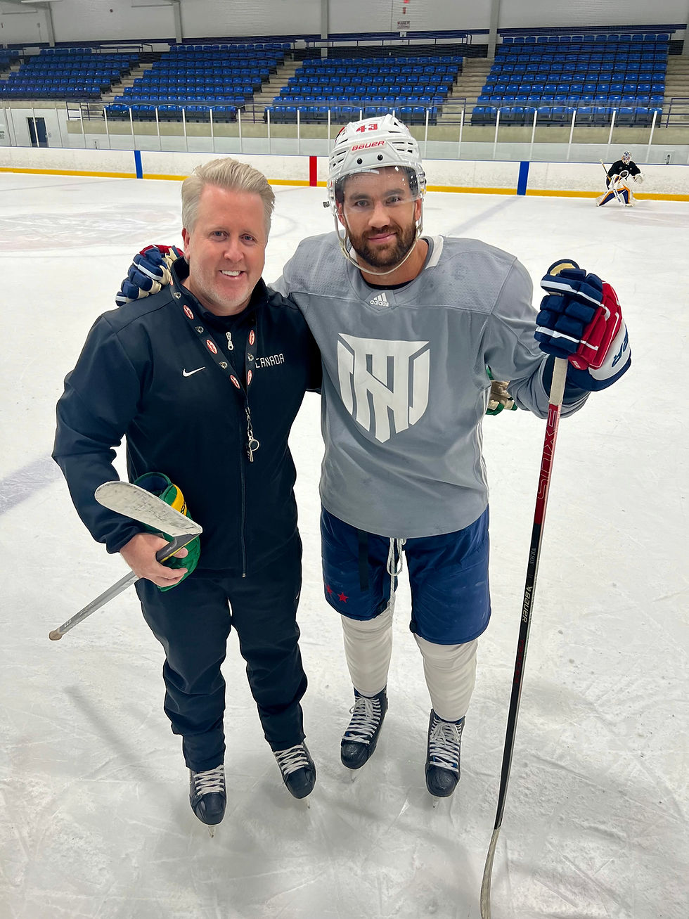 Troy Smith and Tom Wilson during an on ice summer workout run by Smith.