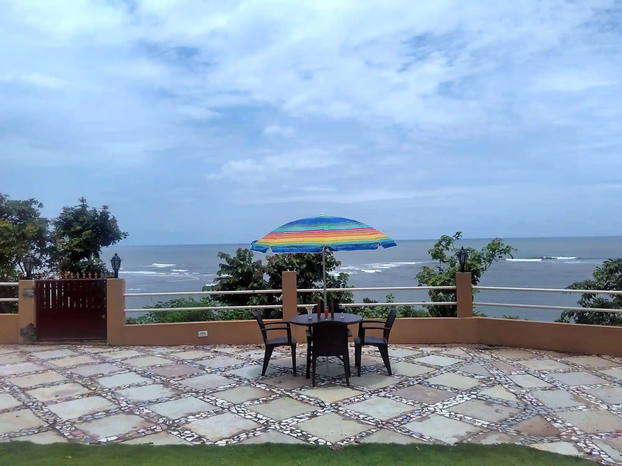 north goa side private beach in a hotel with four chair & an umbrella table