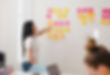woman placing sticky notes on wall_edited.jpg
