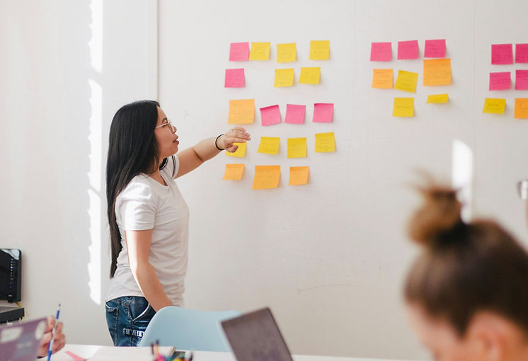 woman placing sticky notes on wall_edited.jpg
