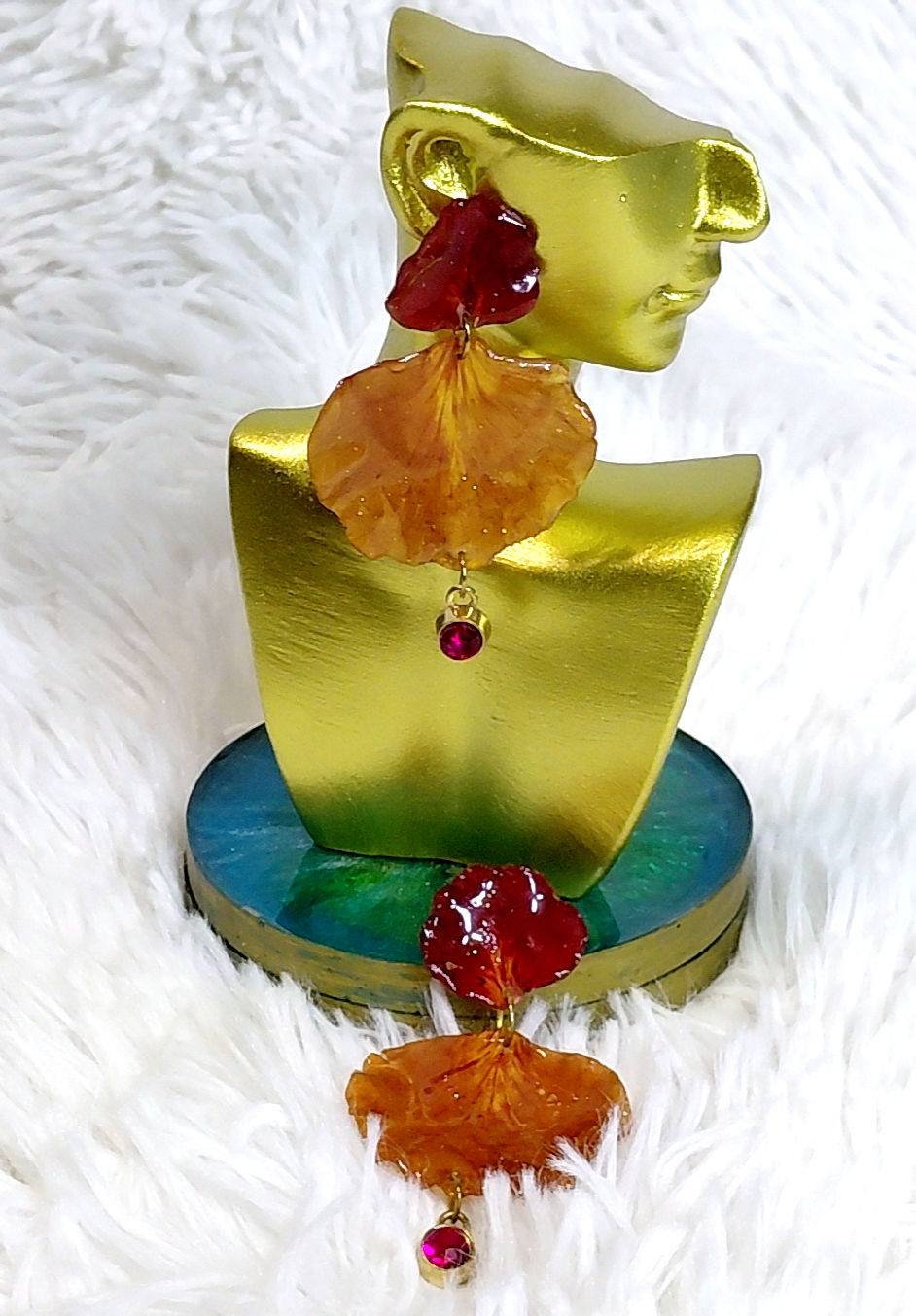 Thumbnail: Detailed close-up of Flame Blossom handcrafted resin earrings on a gold stand - High-shine botanical jewelry.