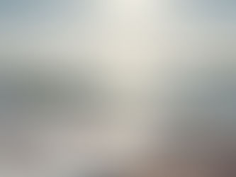 a beach with waves and sun shining