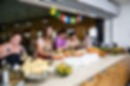 Retreat attendees serve themselves fresh, nourishing food during a seasonal retreat rooted in nature.