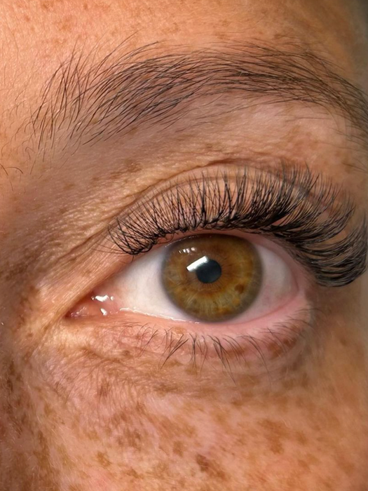 Close-up of a client’s eyes after lash extensions at the lash lounge in south burlington vermont