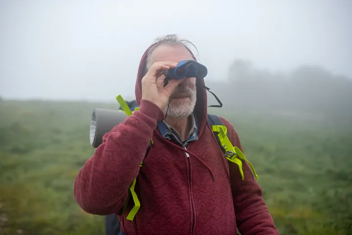 A hiker with binoculars