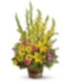 A stunning yellow funeral spray in a basket