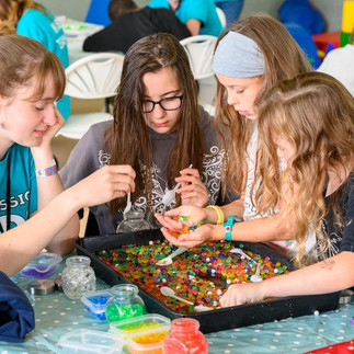 4 girls playing with beads
