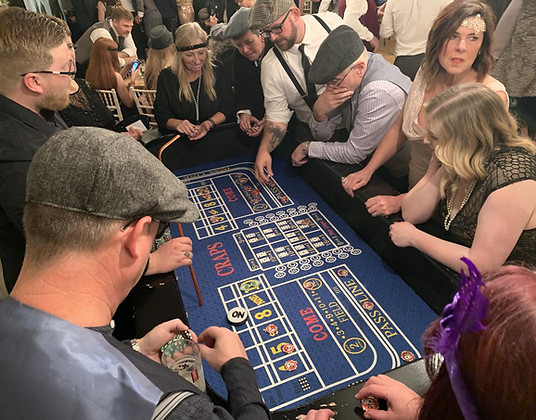 Professional croupier running a Craps table