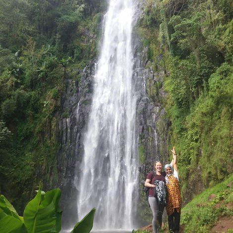 Vics and Aida standing next to incredible Materuni waterfalls in Tanzania