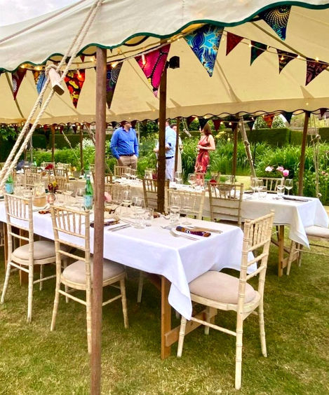 Colourful bunting hung up and napkins on the table setting for a 50th Birthday party