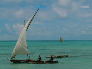 A traditional dhow boat sails on the Indian ocean in Zanzibar