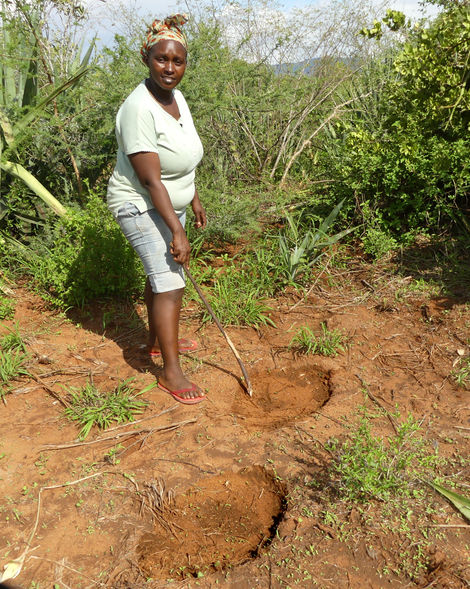 Rosie highlighting the size of elephant footprints on their farm in Kajire, Kasigau, Taita Taveta, Kenya