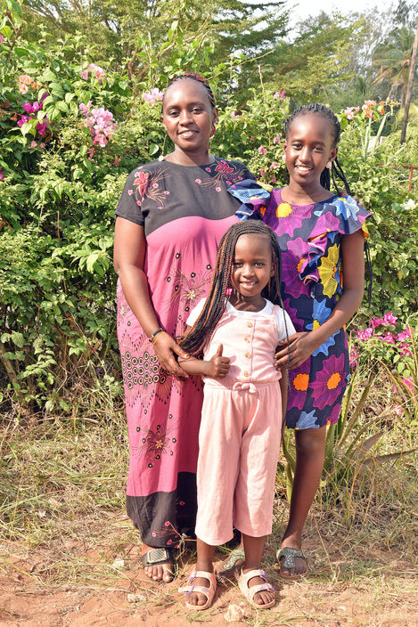 Rosie, Operations Manager, standing with her children, Nicole and Victoria