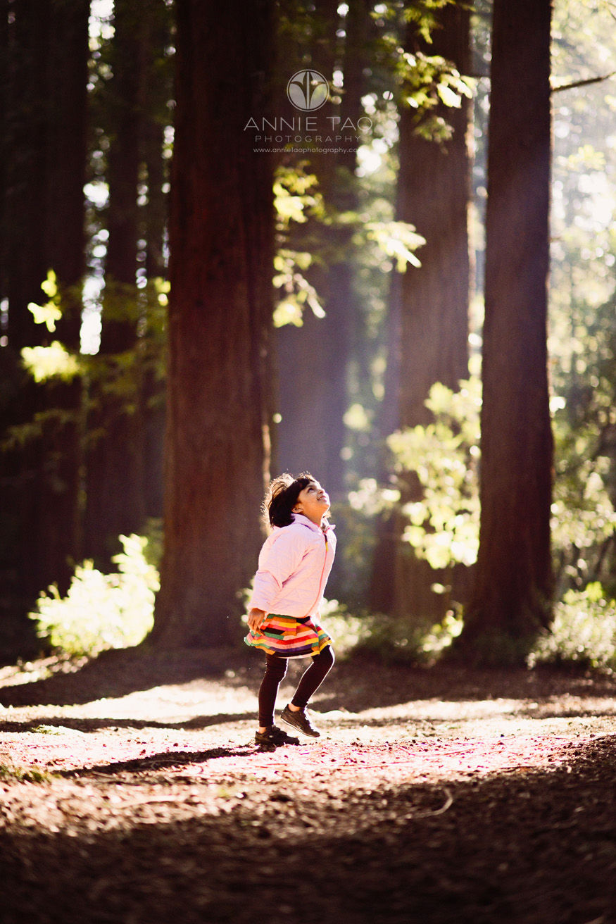 east-bay-lifestyle-children-photography-young-girl-looking-towards-the-light-in-woods-lg