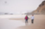 San-Francisco-engagement-photography-couple-walking-on-beach-by-golden-gate-bridge