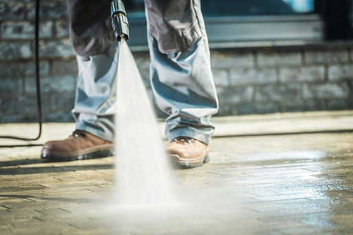 Man-washing-concrete-with-a-pressure-washer.jpg