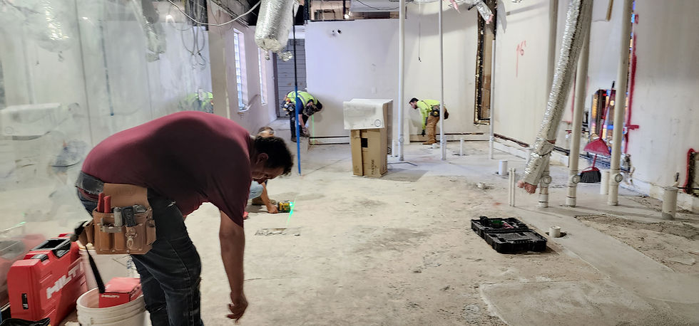 Miami commercial construction interior build-out with workers installing systems.