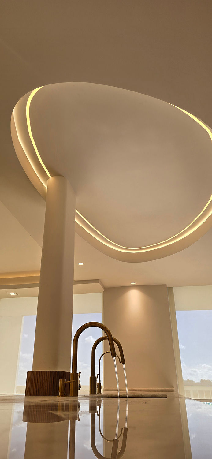 Curved ceiling with recessed lighting in a renovated Miami residence, executed by Miami Construction Experts to enhance living spaces in Miami home renovations