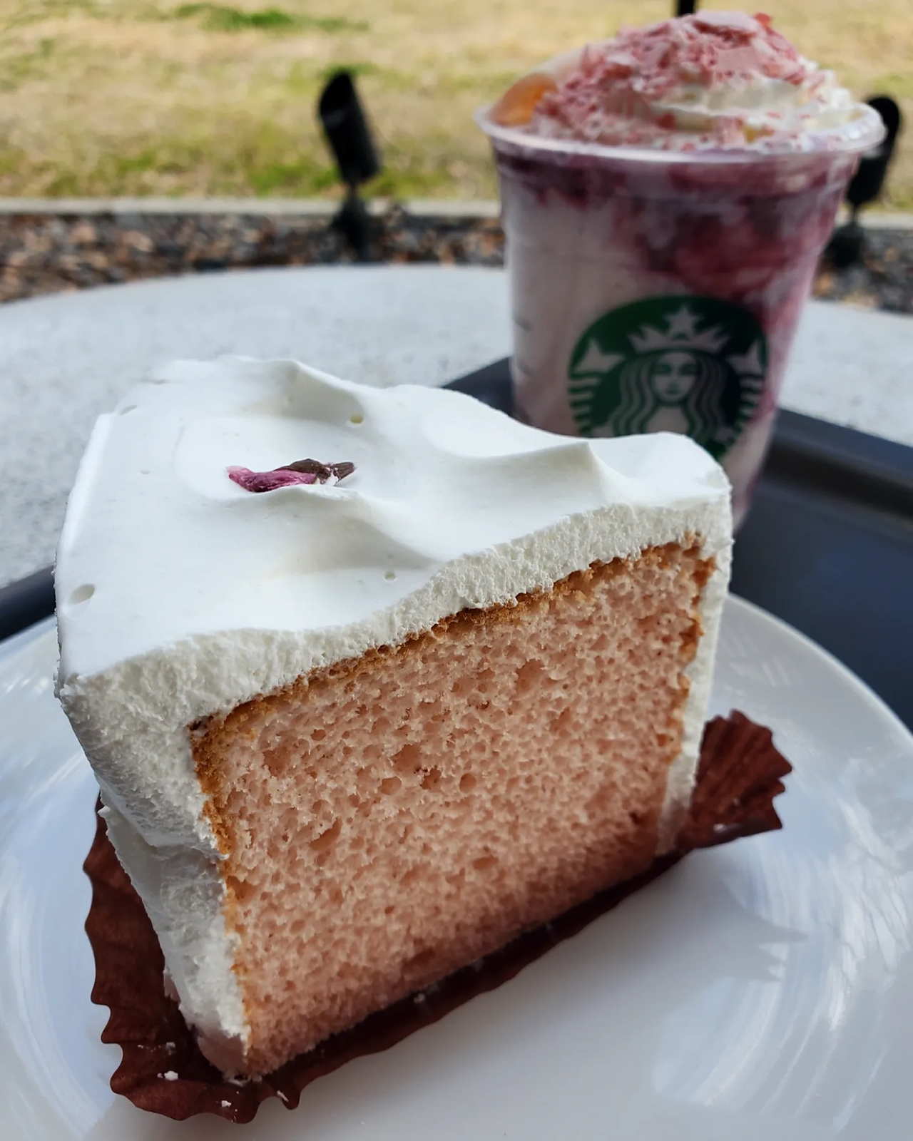 Sakura cassis strawberry shiratama frappuccino in background with sakura chiffon cake in foreground. From Starbucks Japan.
