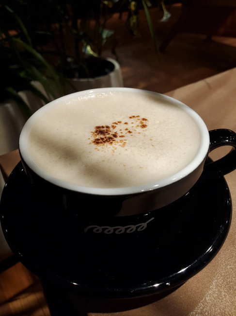Chai latte in black cup at Poool Espresso & Work, Sapporo, Hokkaido Japan
