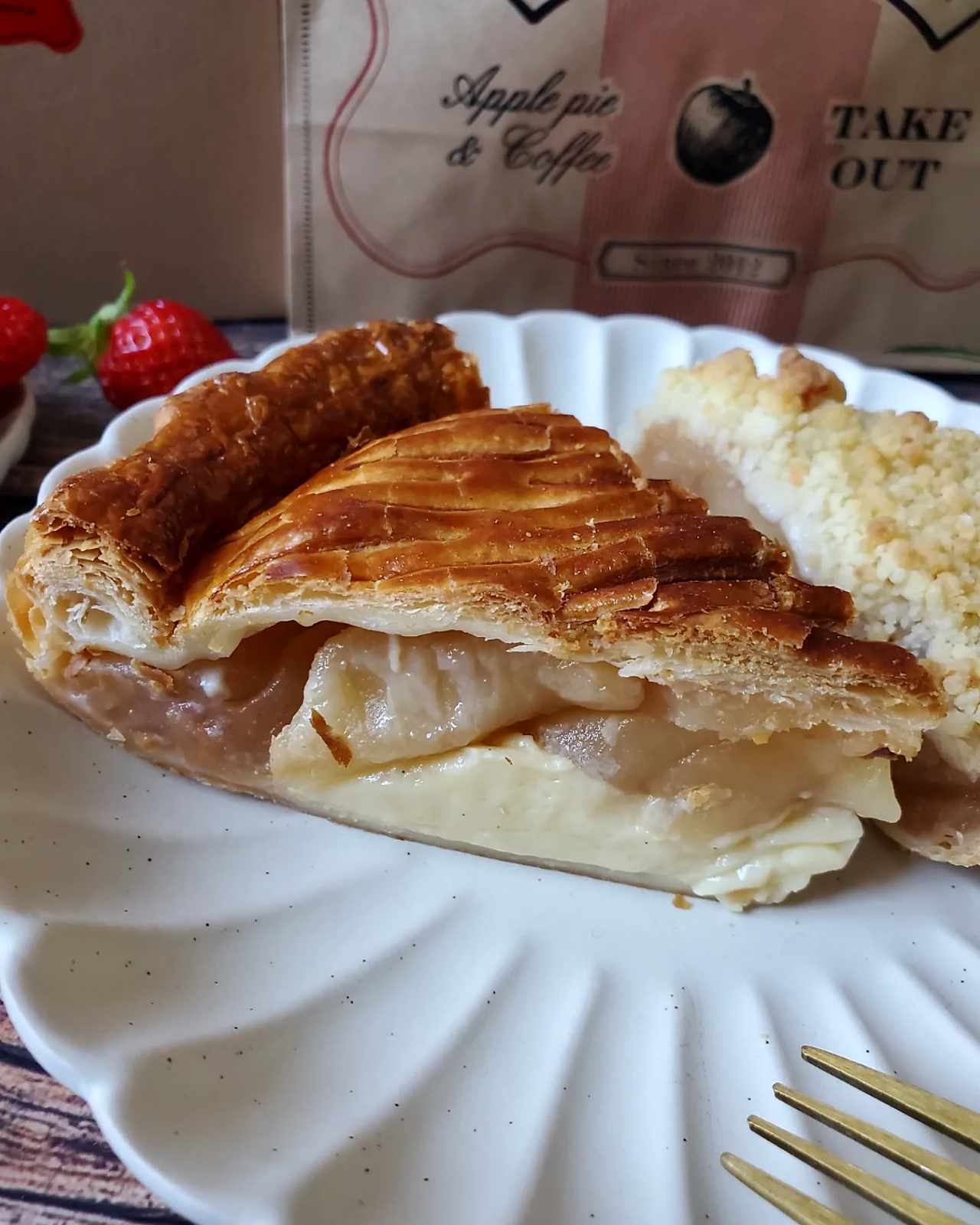 Side view. Two slices of apple pie on a white plate on a wooden background. From Granny Smith Apple Pie & Coffee, Nishinomiya Japan