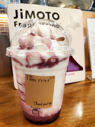 Grape white chocolate frappuccino blended cream (order sticker) with jimoto frappuccino sign in background. From Starbucks Japan.