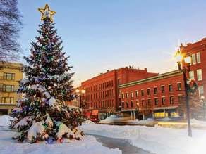 A festive digital holiday card from Community Power Coalition of New Hampshire (CPCNH), featuring illustrated evergreen trees, softly falling snow, and a night sky.