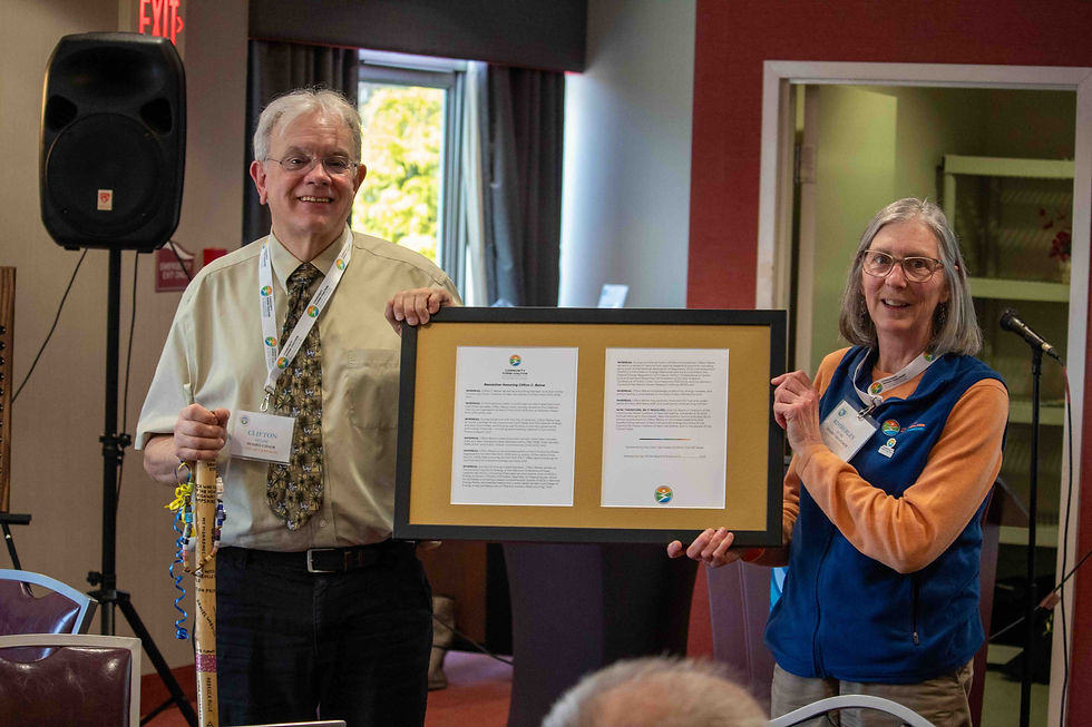 CPCNH Board Chair Kim Quirk and former Chair Clifton Below display a framed resolution honoring Below’s leadership and service during CPCNH’s July 2025 Annual Meeting.