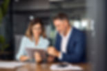 Team of diverse partners mature Latin business man and European business woman discussing