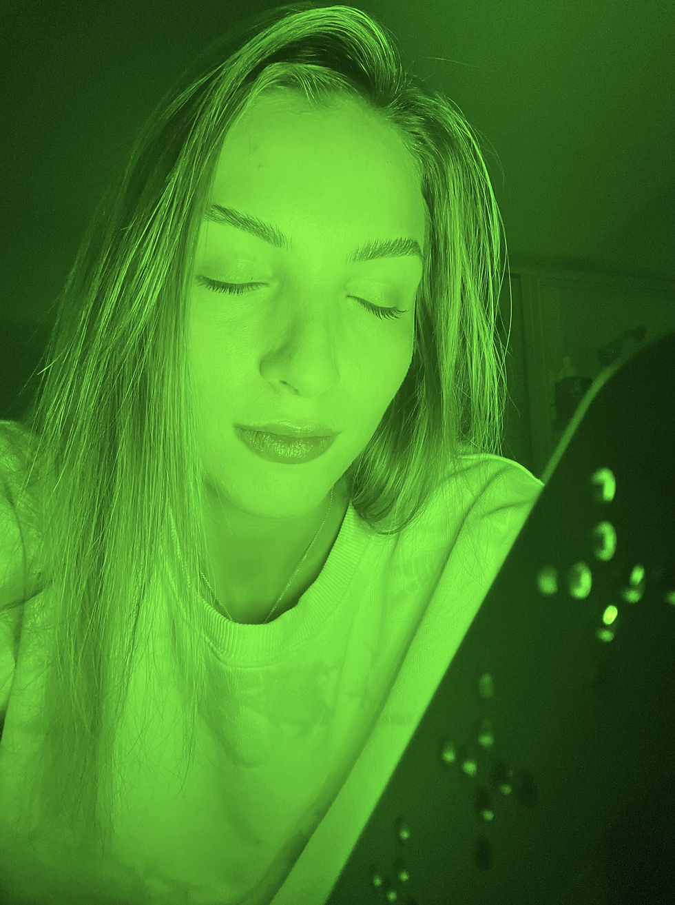 Woman using MyGreen Lamp on face with eyes shut
