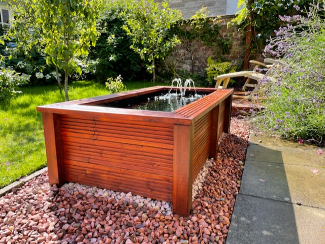 Low level raised pond with seating