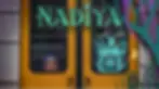 Image of a young girl and Nadiya, the main character of the game, looking worried through the glass of a train door.