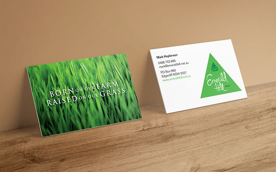 double sided business card that features a photo of real grass on a tan background