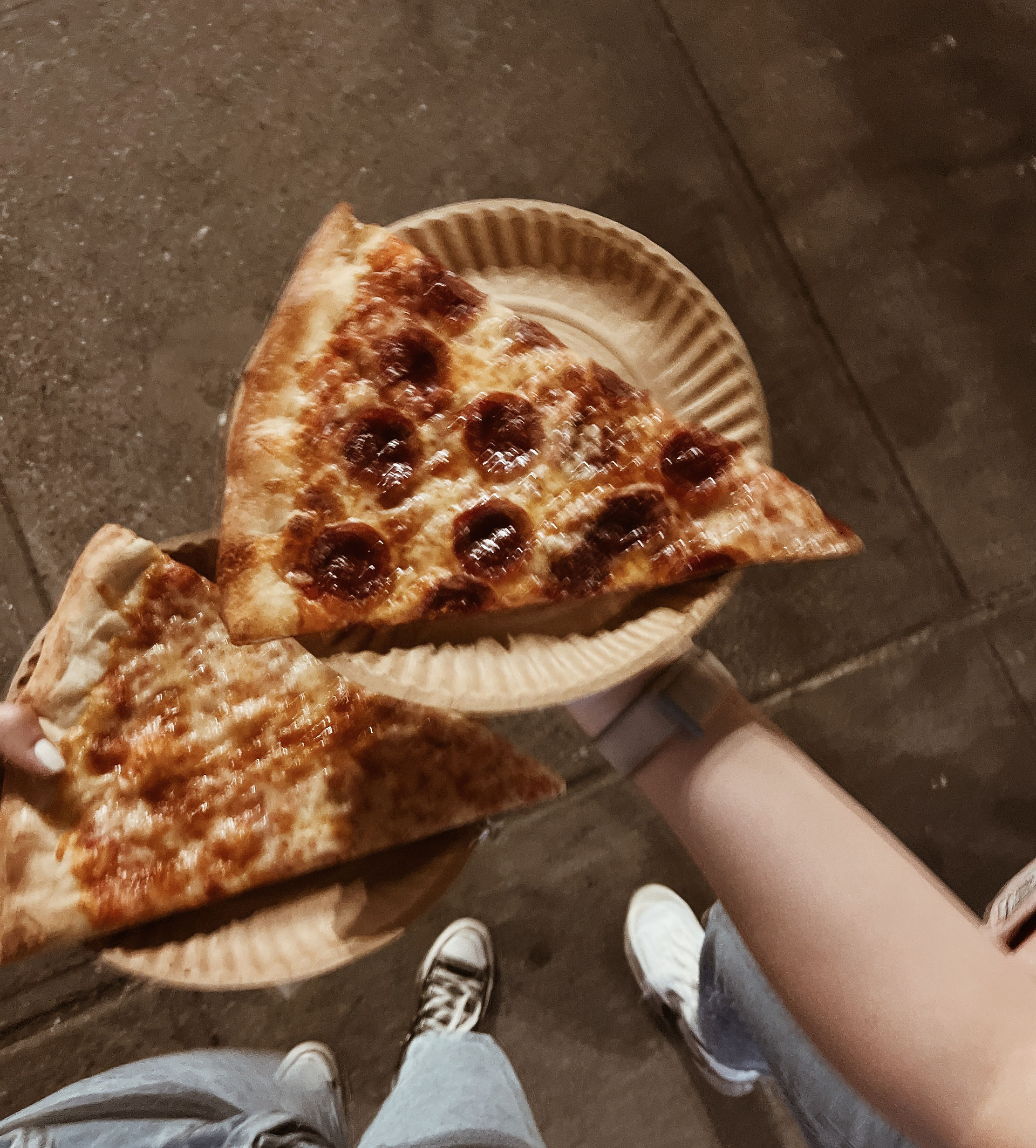 Two blurry slices of pizza, in new york city.