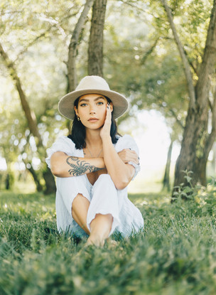 Photo of model posing underneath trees in Bountiful Utah for a portrait session by Jenna Loeva Photography