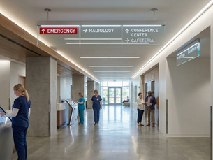 hospital wayfinding signage system with overhead directional signs guiding visitors to emergency, radiology, and conference center