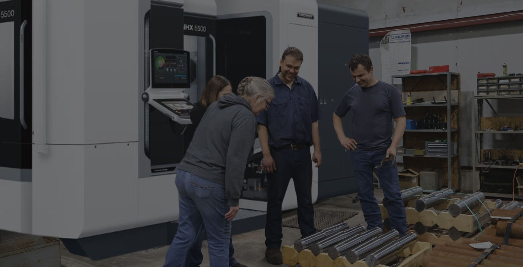 QB Manufacturing - The Machine Shop OEMs Trust inspecting parts in front of the DMG Mori NHX 5500.jpg
