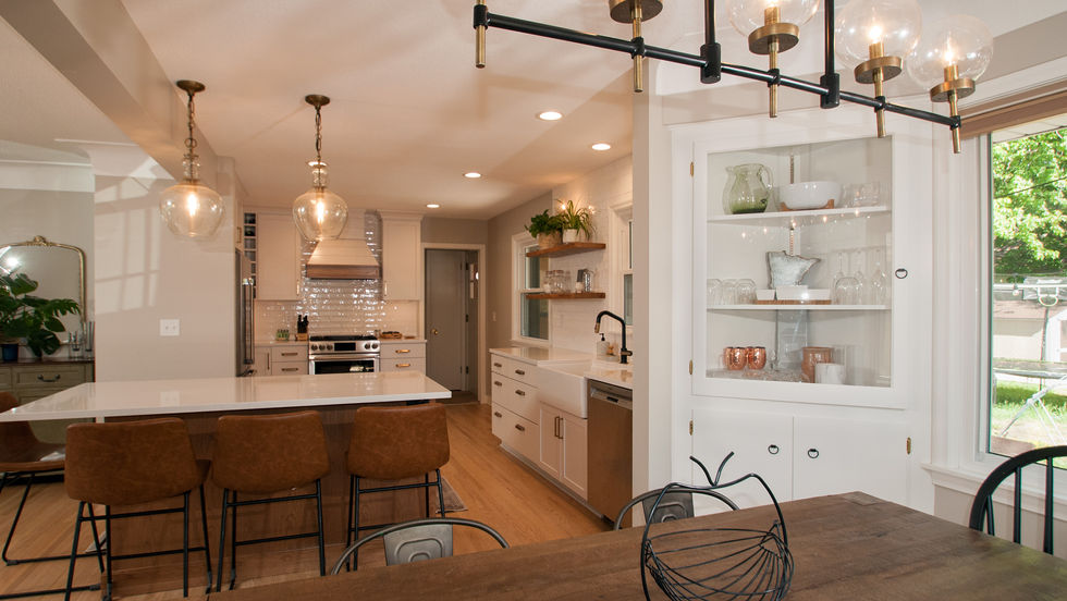 Timeless kitchen with white subway tile backsplash, matte black faucet, and custom drawers.