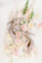 Luxury wedding photography of studded bridal heels and roses.