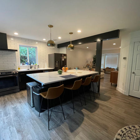 A bright kitchen with a luxurious white quartz countertop, complemented by modern appliances and cabinetry.