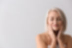 Relaxed woman touching face